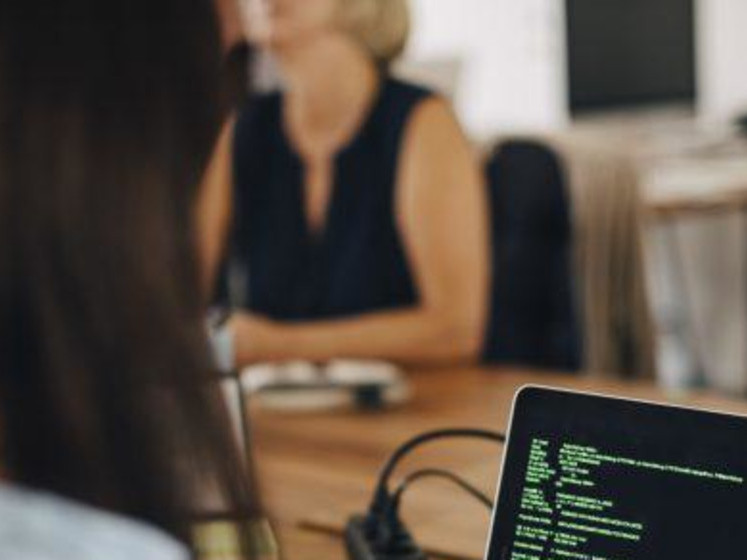 Woman with laptop and code